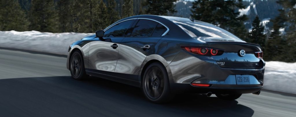 A new Mazda3 drives on a mountainous road through a winter scene. Shop for your new Mazda3 at Mazda of Spartanburg today!