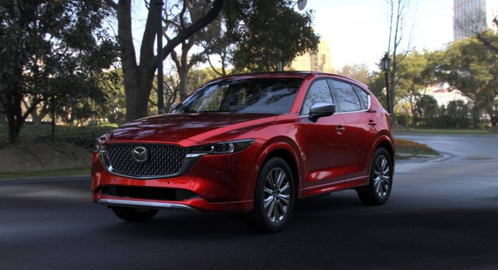 A red new 2025 Mazda CX-5 SUV drives on a road, making this perfect for your holiday travel plans. Shop for your new Mazda CX-5 near Greenville at Mazda of Spartanburg.