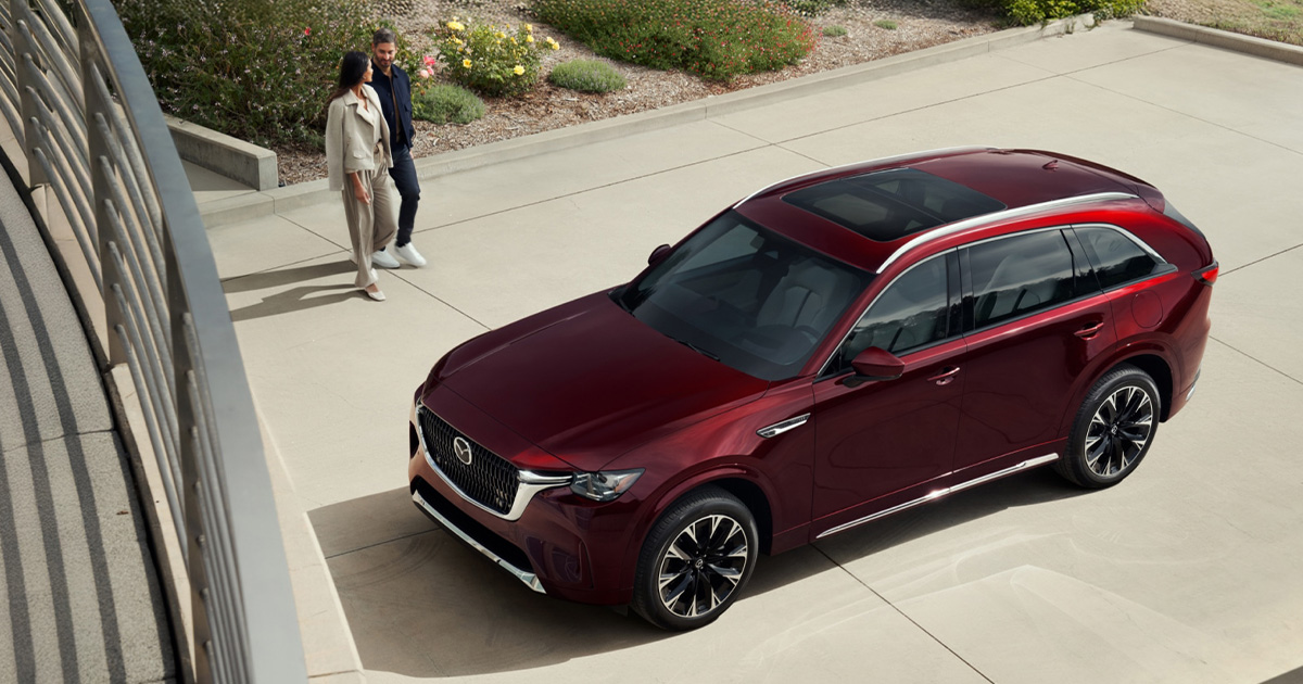 A Mazda CX-90 parked in the owner's driveway.